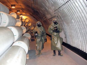 WORKERS IN POISON-PROOF SUITS EXAMINE VX NERVE GAS CYLINDERS AT A FEDERAL DISPOSAL SITE IN NORTHEAST INDIANA. THESE DAYS, NERVE GAS AND OTHER MILITARY POISONS CAN BE SAFELY NEUTRALIZED ON LAND. DURING THE COLD WAR, THOUGH, LEFTOVER MUNITIONS WERE DUMPED IN THE ATLANTIC, PACIFIC, AND GULF OF MEXICO, ON THE THEORY OF "OUT OF SIGHT, OUT OF MIND." TO THIS DAY, THEY REST ON OCEAN FLOORS, THEIR STEEL FANGS DRIPPING POISON, READY TO SPEW DEATH IF DISTURBED. WORKERS IN POISON-PROOF SUITS EXAMINE VX NERVE GAS CYLINDERS AT A FEDERAL DISPOSAL SITE IN NORTHEAST INDIANA. THESE DAYS, NERVE GAS AND OTHER MILITARY POISONS CAN BE SAFELY NEUTRALIZED ON LAND. DURING THE COLD WAR, THOUGH, LEFTOVER MUNITIONS WERE DUMPED IN THE ATLANTIC, PACIFIC, AND GULF OF MEXICO, ON THE THEORY OF "OUT OF SIGHT, OUT OF MIND." TO THIS DAY, THEY REST ON OCEAN FLOORS, THEIR STEEL FANGS DRIPPING POISON, READY TO SPEW DEATH IF DISTURBED.